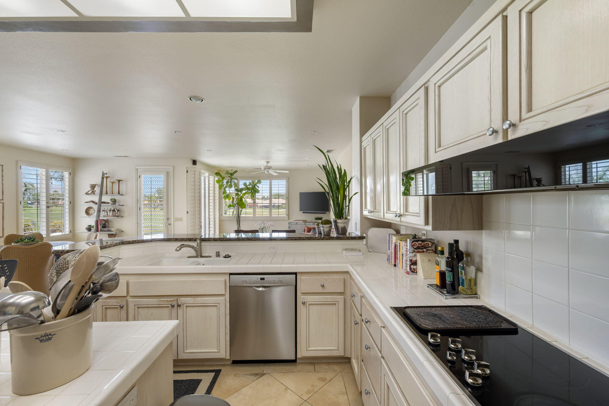57084 Merion La Quinta, CA 92253 - Photo 38 of 56 a kitchen with stainless steel appliances a sink stove and cabinets