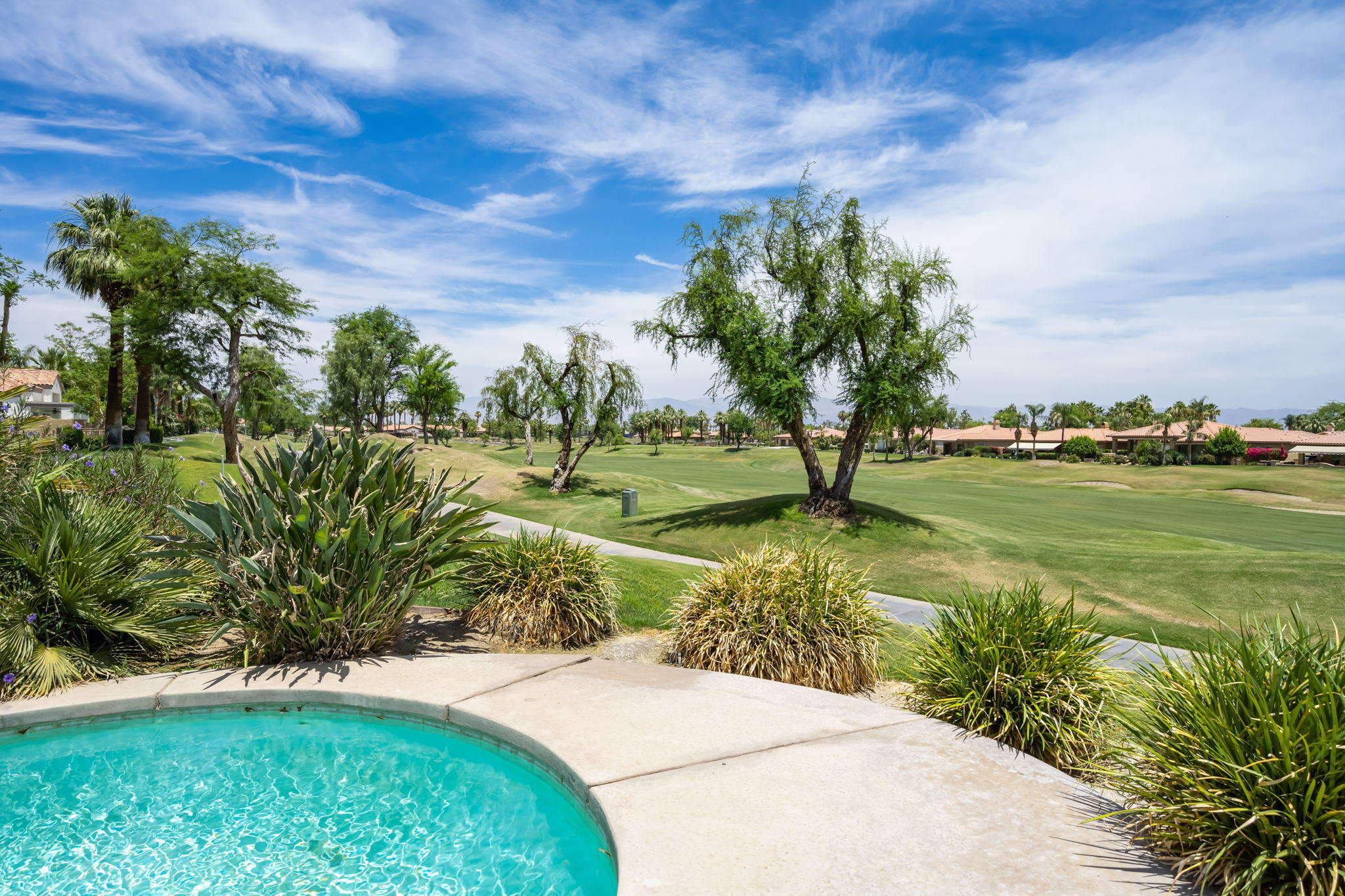 57084 Merion La Quinta, CA 92253 - Photo 44 of 56 a view of a garden with a building in the background