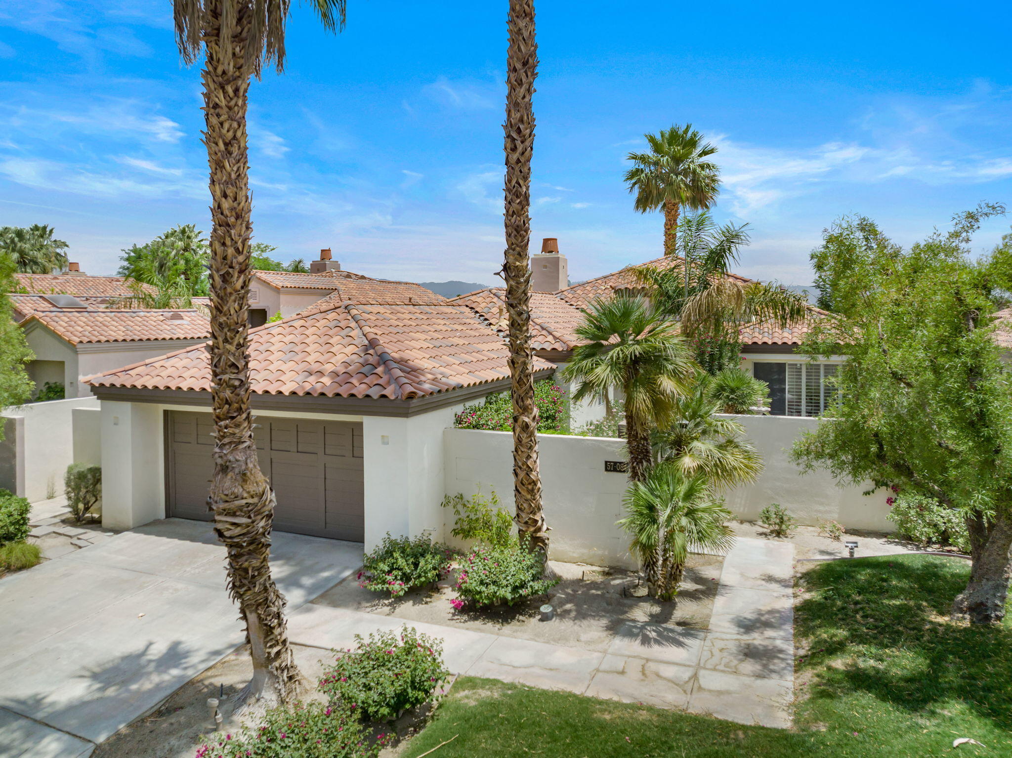 57084 Merion La Quinta, CA 92253 - Photo 5 of 56 a front view of a house with garden