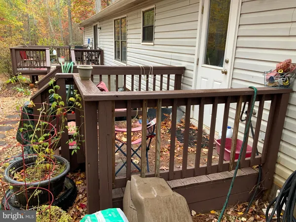 a view of a chairs and table in the balcony