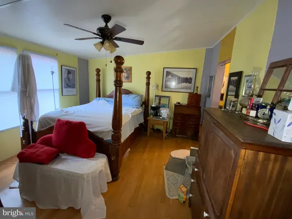 a bedroom with bed and a chandelier