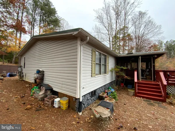 a backyard of a house with barbeque oven table and chairs