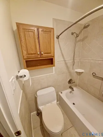 a bathroom with a toilet sink shower and mirror