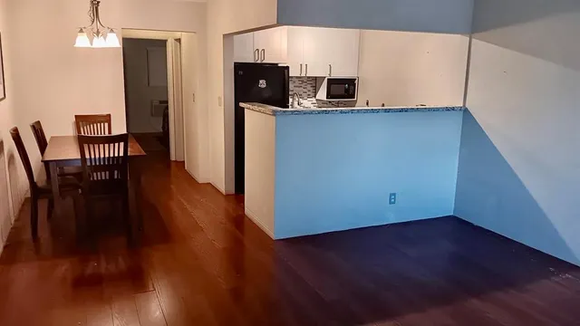 a kitchen with stainless steel appliances a refrigerator and microwave