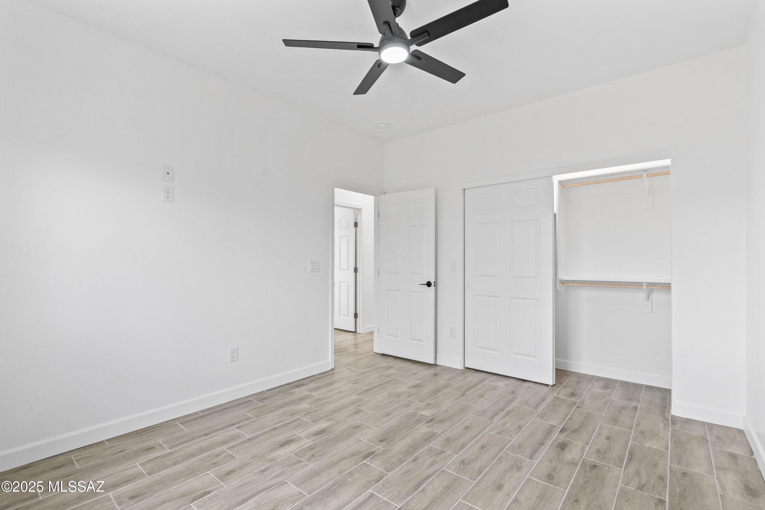 1851 Calle Salmon Rio Rico, AZ 85648 - Photo 21 of 29 a view of a room with wooden floor and ceiling fan