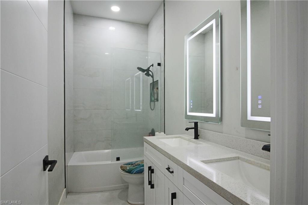 3902 4th Street Southwest Lehigh Acres, FL 33976 - Photo 20 of 34 Dual vanity with integrated sinks and a light-toned countertop