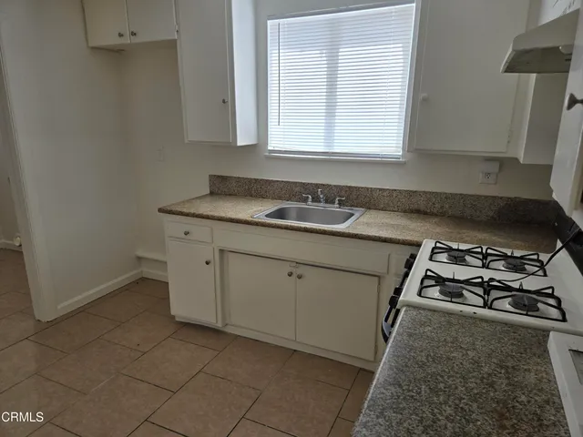 a kitchen with sink and stove