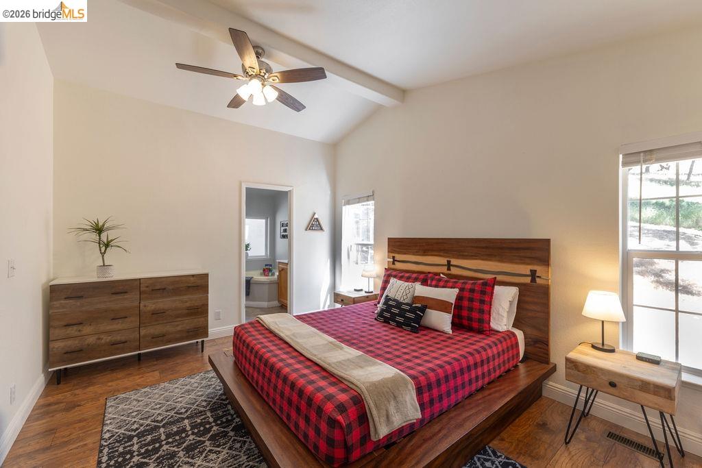 20828 Ferretti Road Groveland, CA 95321 - Photo 13 of 60 Bedroom with dark wood-style floors, lofted ceiling with beams, connected bathroom, and ceiling fan
