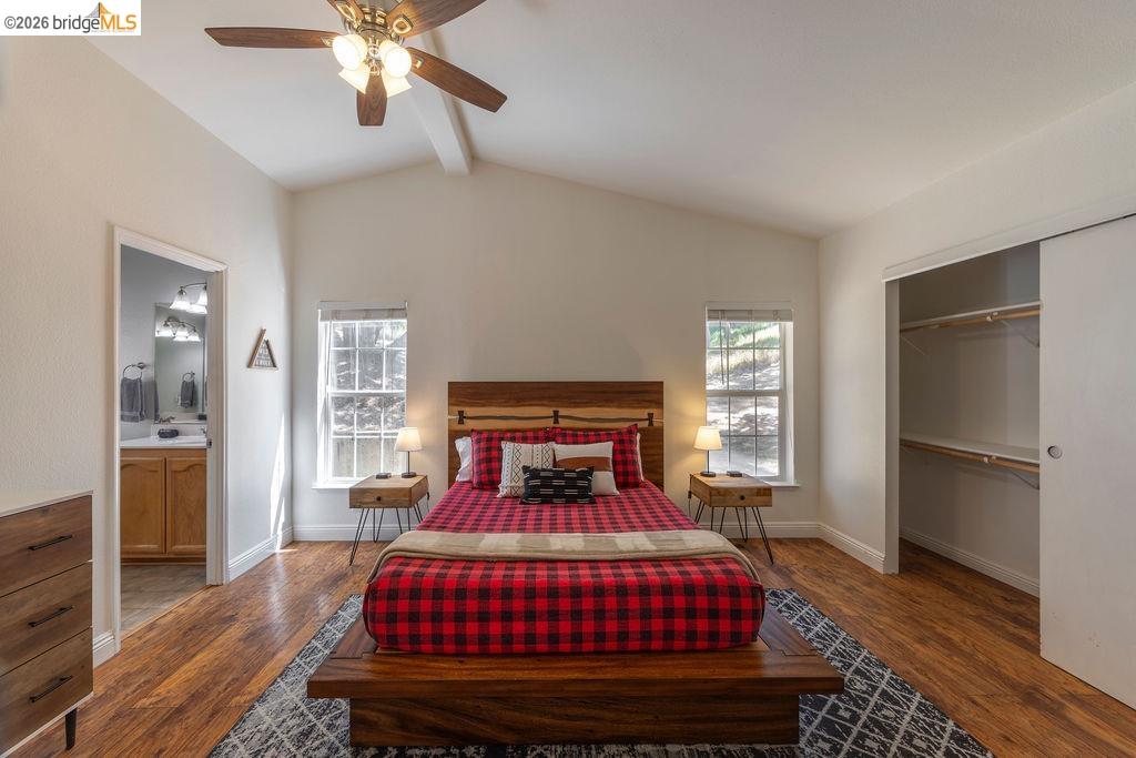 20828 Ferretti Road Groveland, CA 95321 - Photo 14 of 60 Bedroom featuring beamed ceiling, a closet, wood finished floors, ceiling fan, and connected bathroom