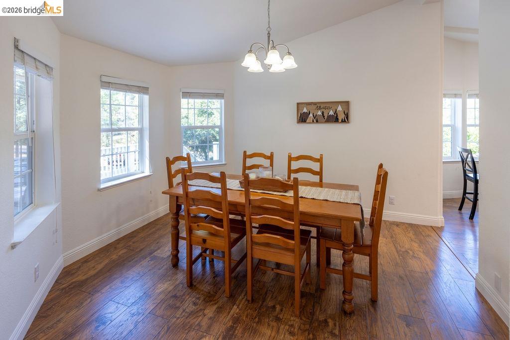 20828 Ferretti Road Groveland, CA 95321 - Photo 20 of 60 Dining space featuring dark wood-type flooring, lofted ceiling, and hanging lights