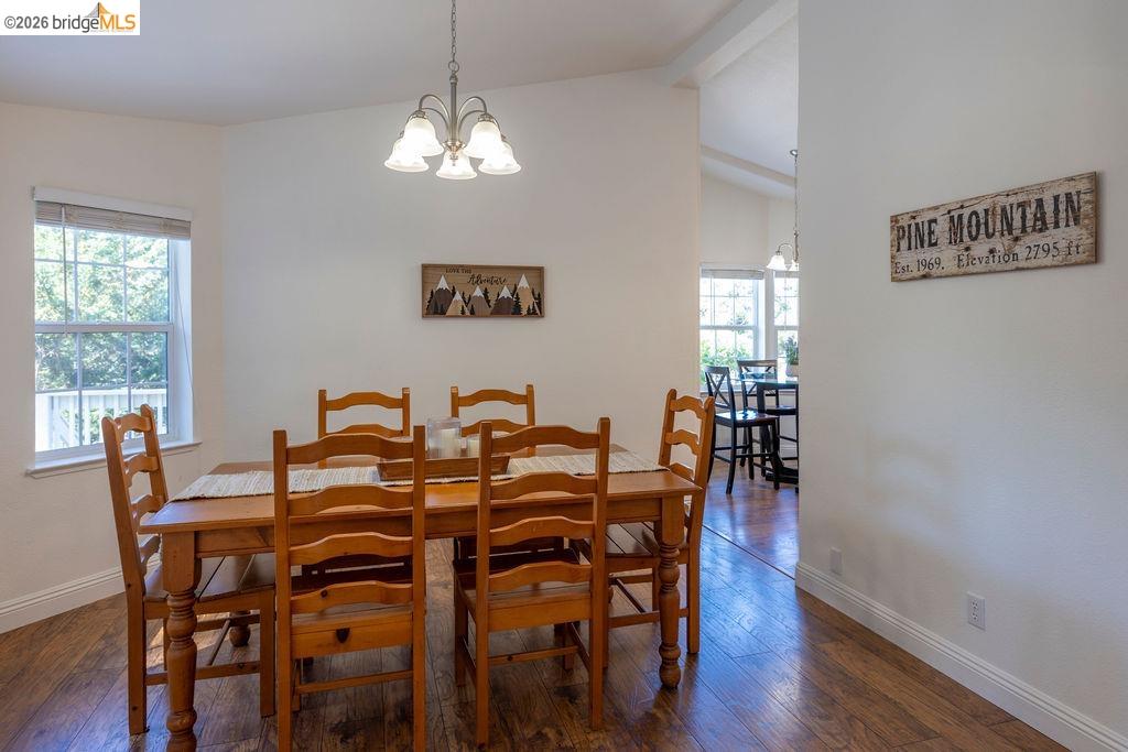 20828 Ferretti Road Groveland, CA 95321 - Photo 23 of 60 Dining room with hanging lights, dark wood-style flooring, and lofted ceiling