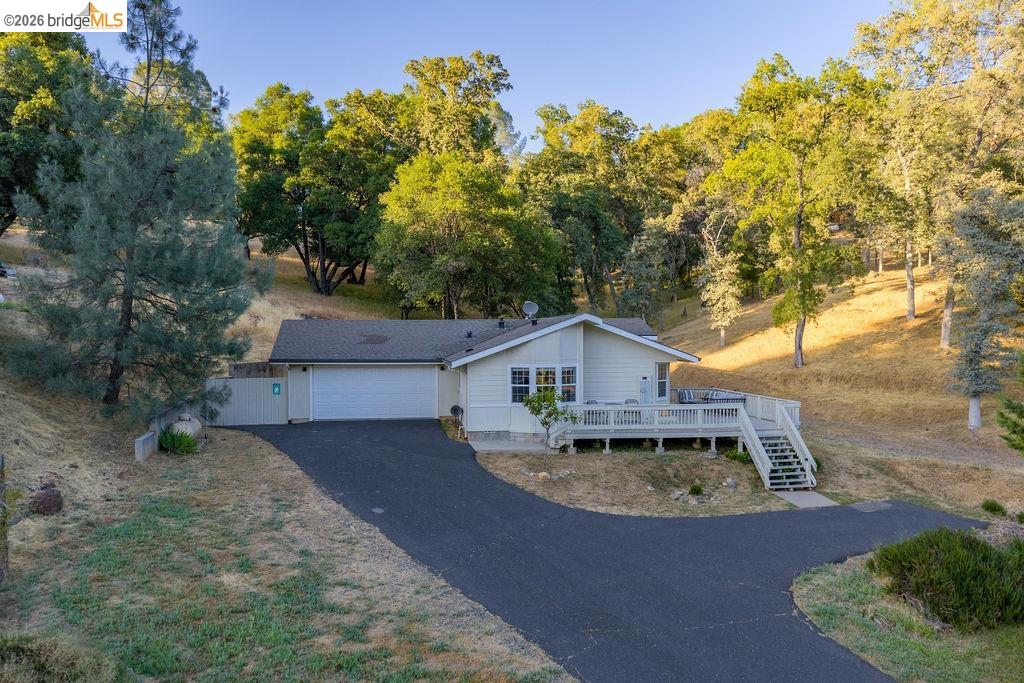20828 Ferretti Road Groveland, CA 95321 - Photo 59 of 60 Single story home with a deck, driveway, an attached garage, and view of wooded area