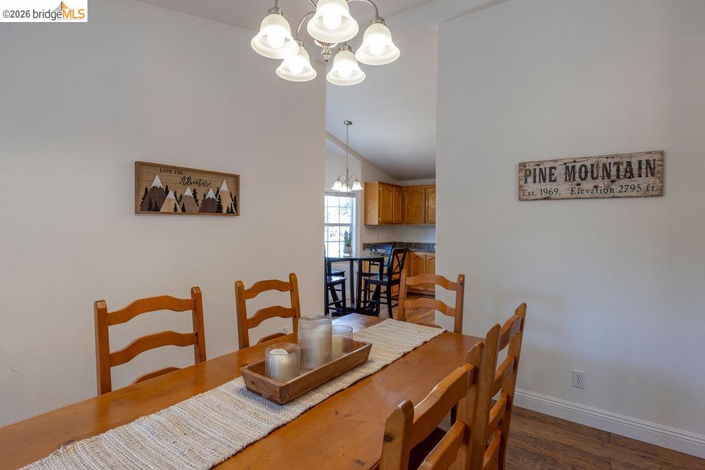 20828 Ferretti Road Groveland, CA 95321 - Photo 6 of 60 Dining room with hanging lights, lofted ceiling, and dark wood-style floors
