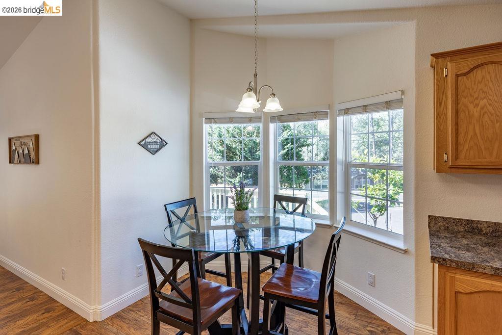 20828 Ferretti Road Groveland, CA 95321 - Photo 8 of 60 Dining room featuring a textured wall, hanging lights, and dark wood-type flooring