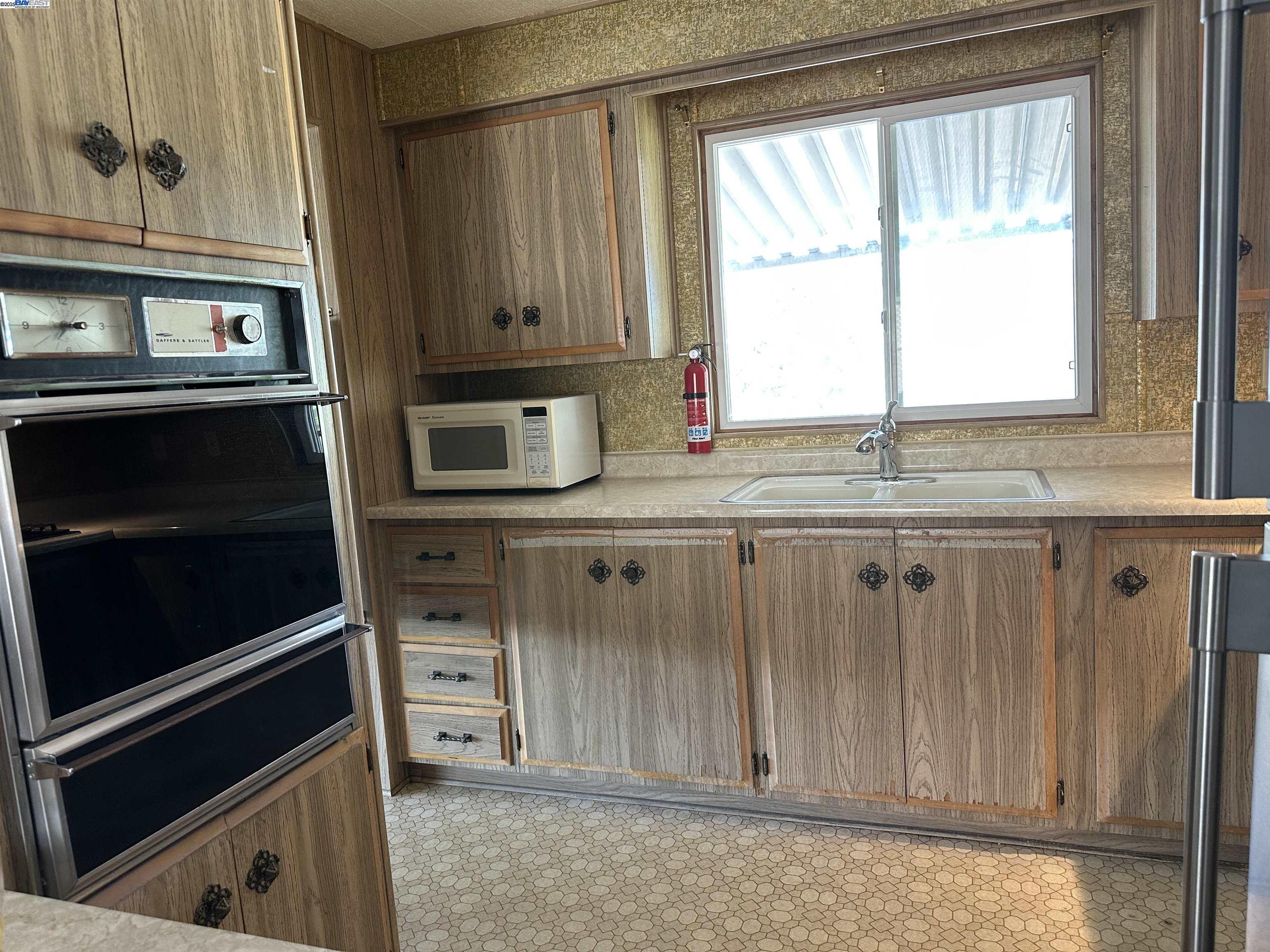 711 Old Canyon Road, Unit 77 Fremont, CA 94538 - Photo 20 of 39 a kitchen with granite countertop cabinets stainless steel appliances and a window
