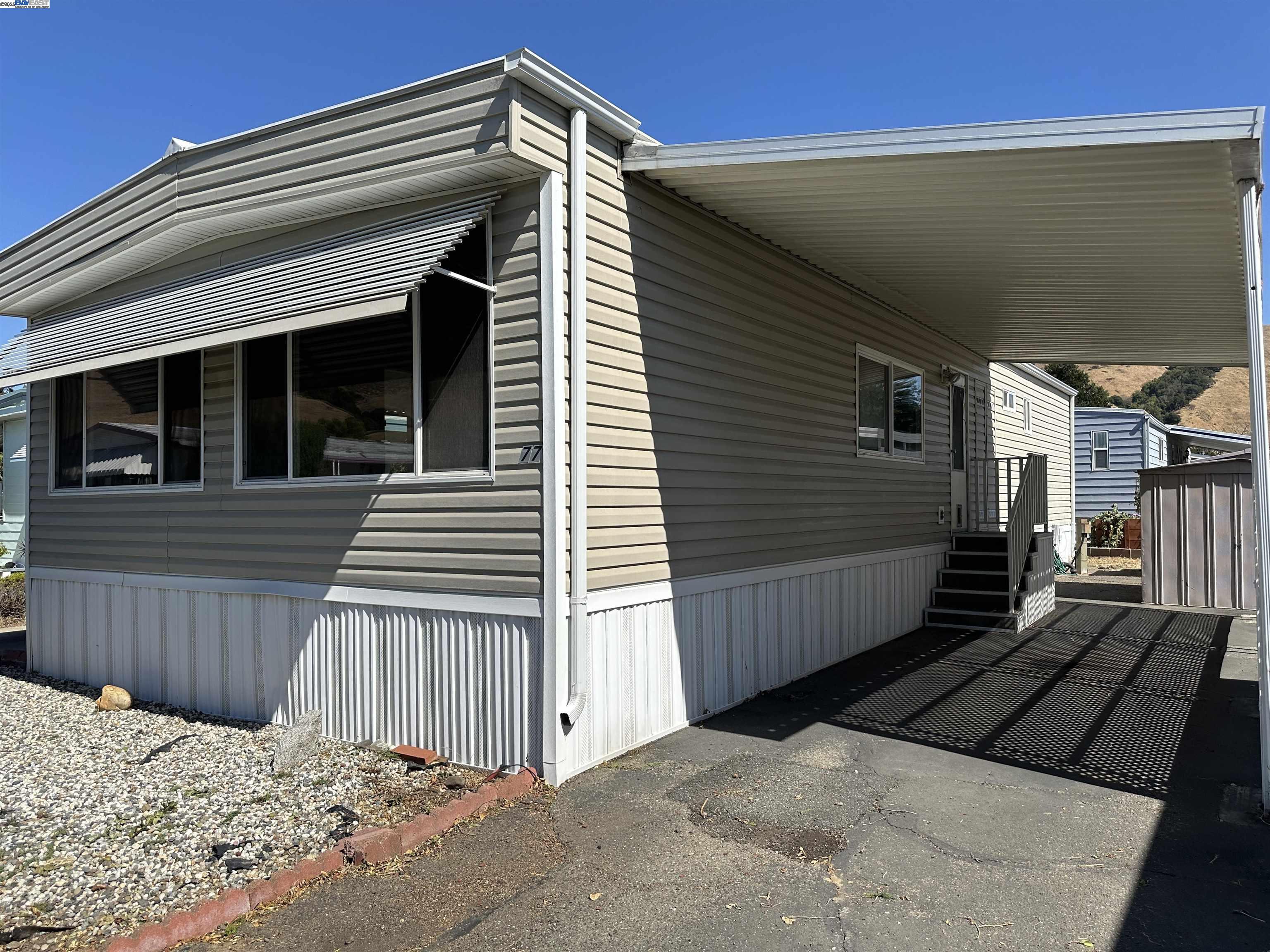 711 Old Canyon Road, Unit 77 Fremont, CA 94538 - Photo 3 of 39 a view of a house with a wooden fence