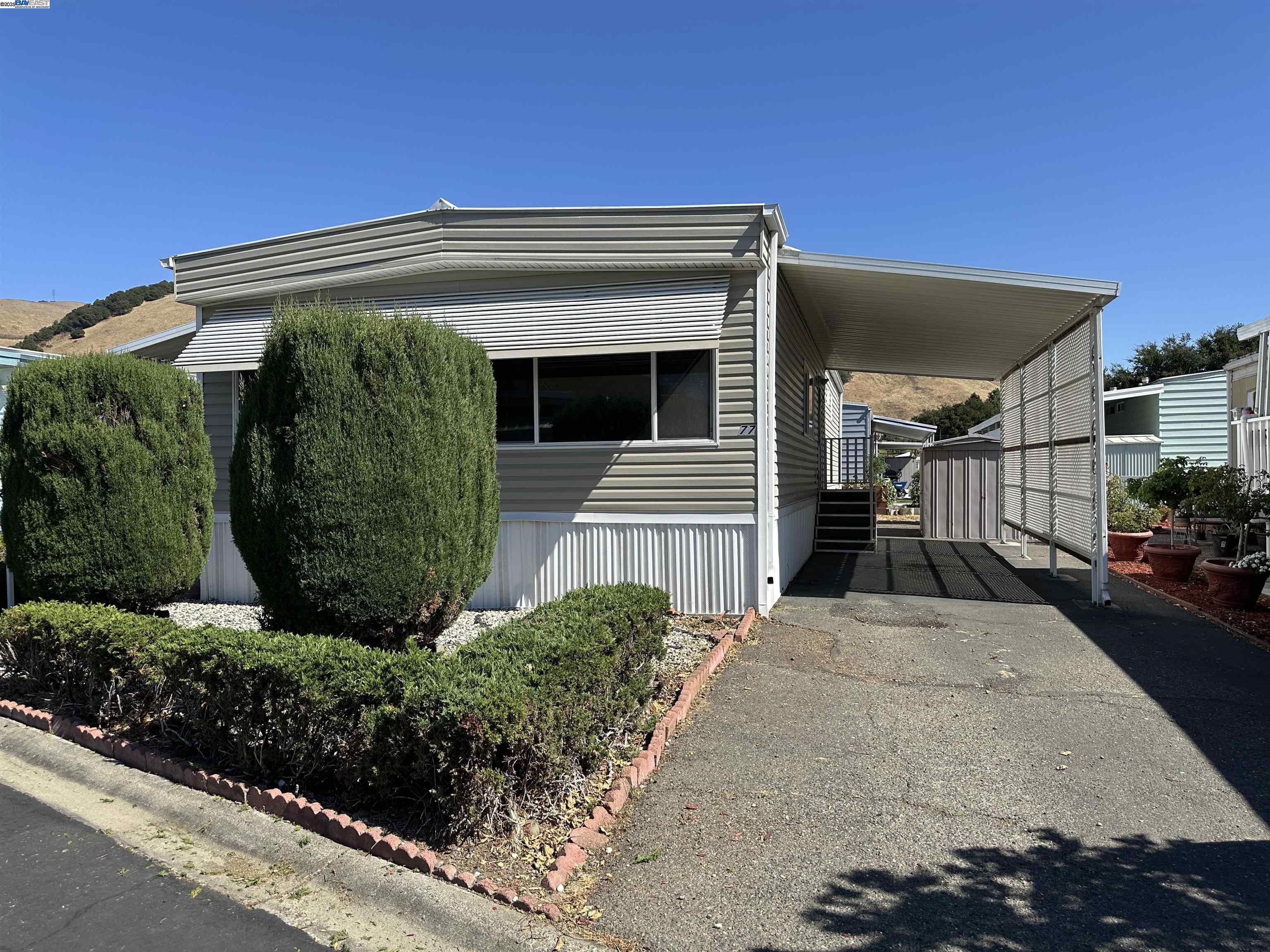 711 Old Canyon Road, Unit 77 Fremont, CA 94538 - Photo 4 of 39 a view of a house with a yard