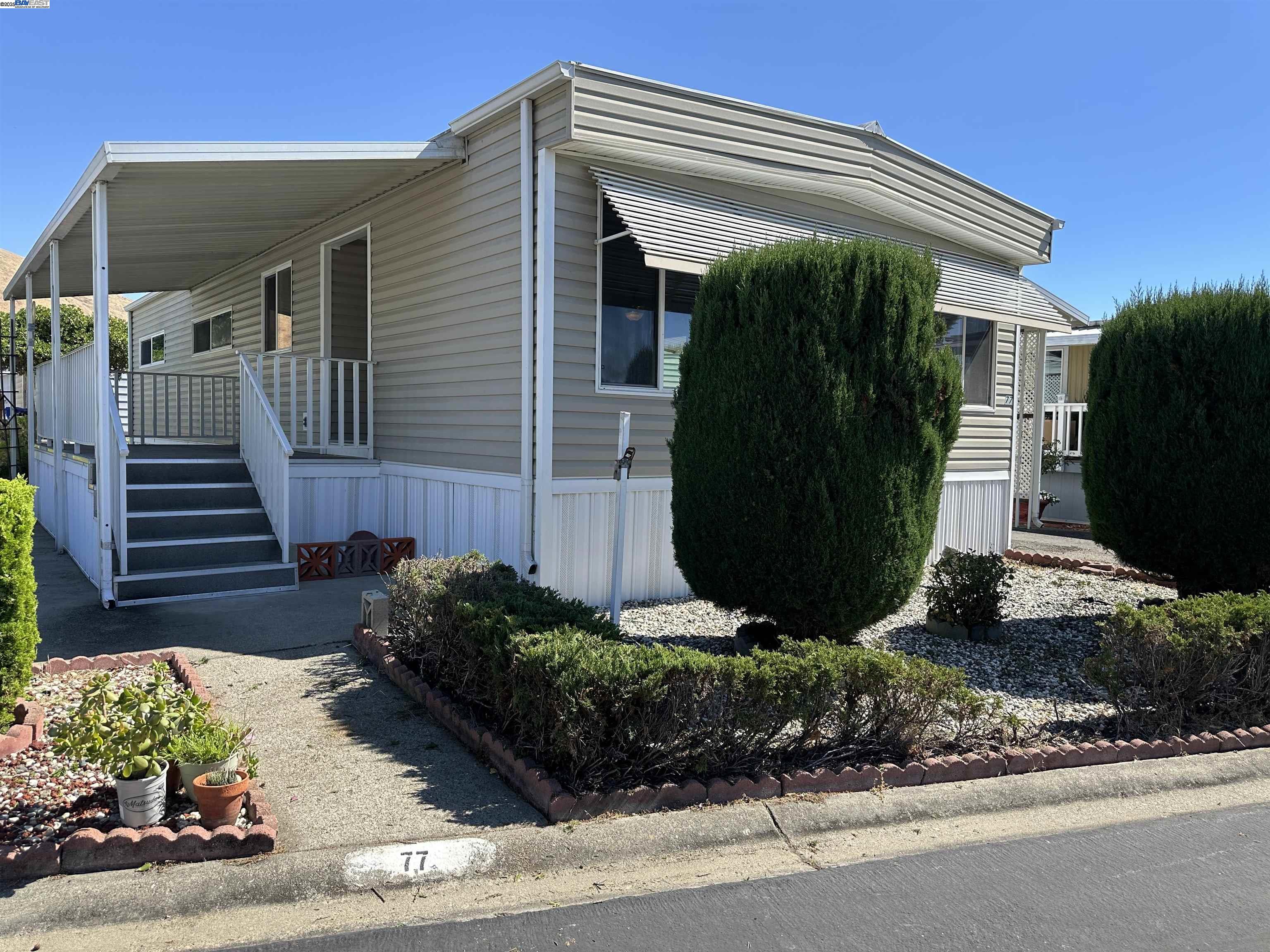 711 Old Canyon Road, Unit 77 Fremont, CA 94538 - Photo 5 of 39 a view of a house with a yard