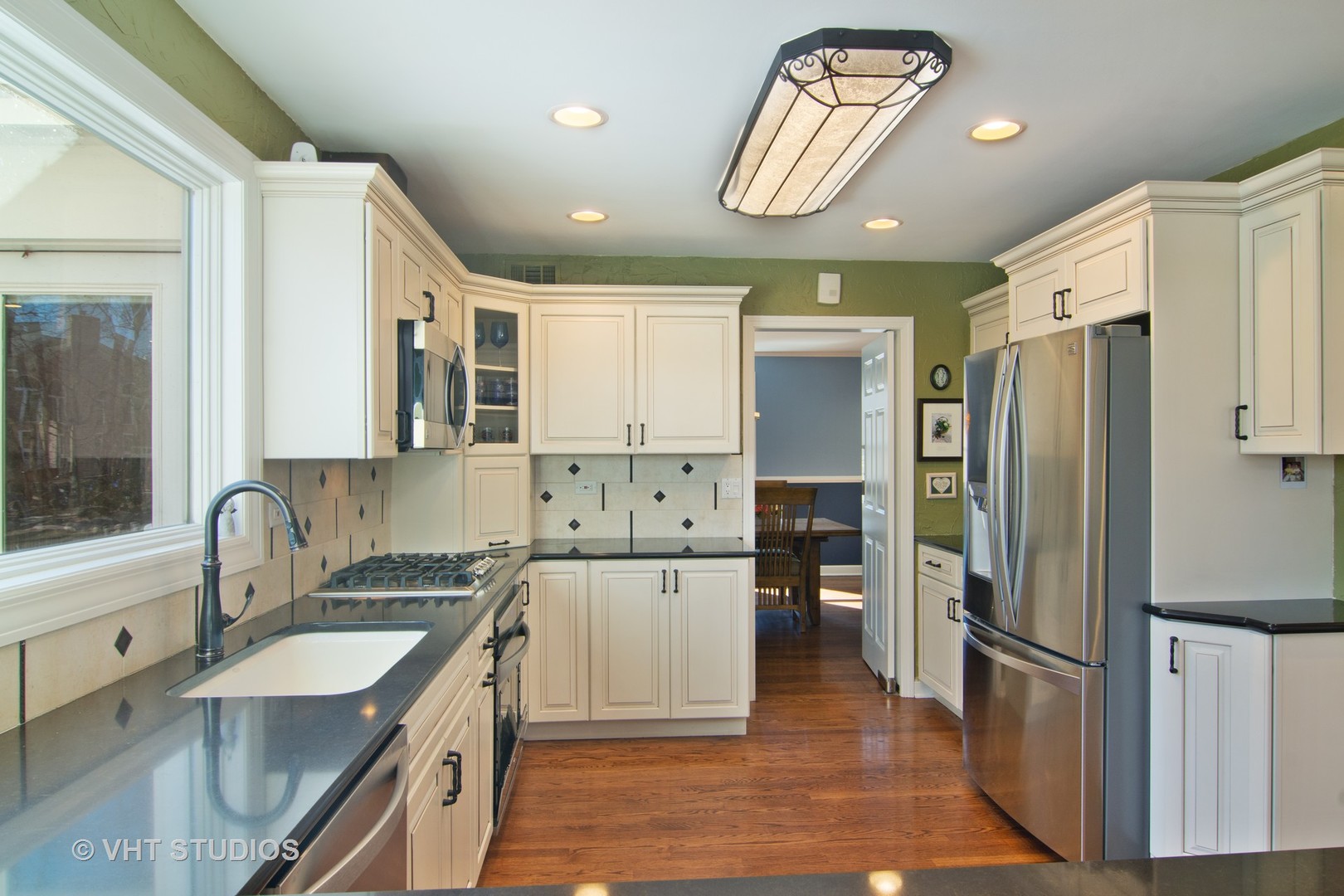 2140 West Baldwin Road Inverness, IL 60067 - Photo 5 of 32 a kitchen with a refrigerator sink and cabinets
