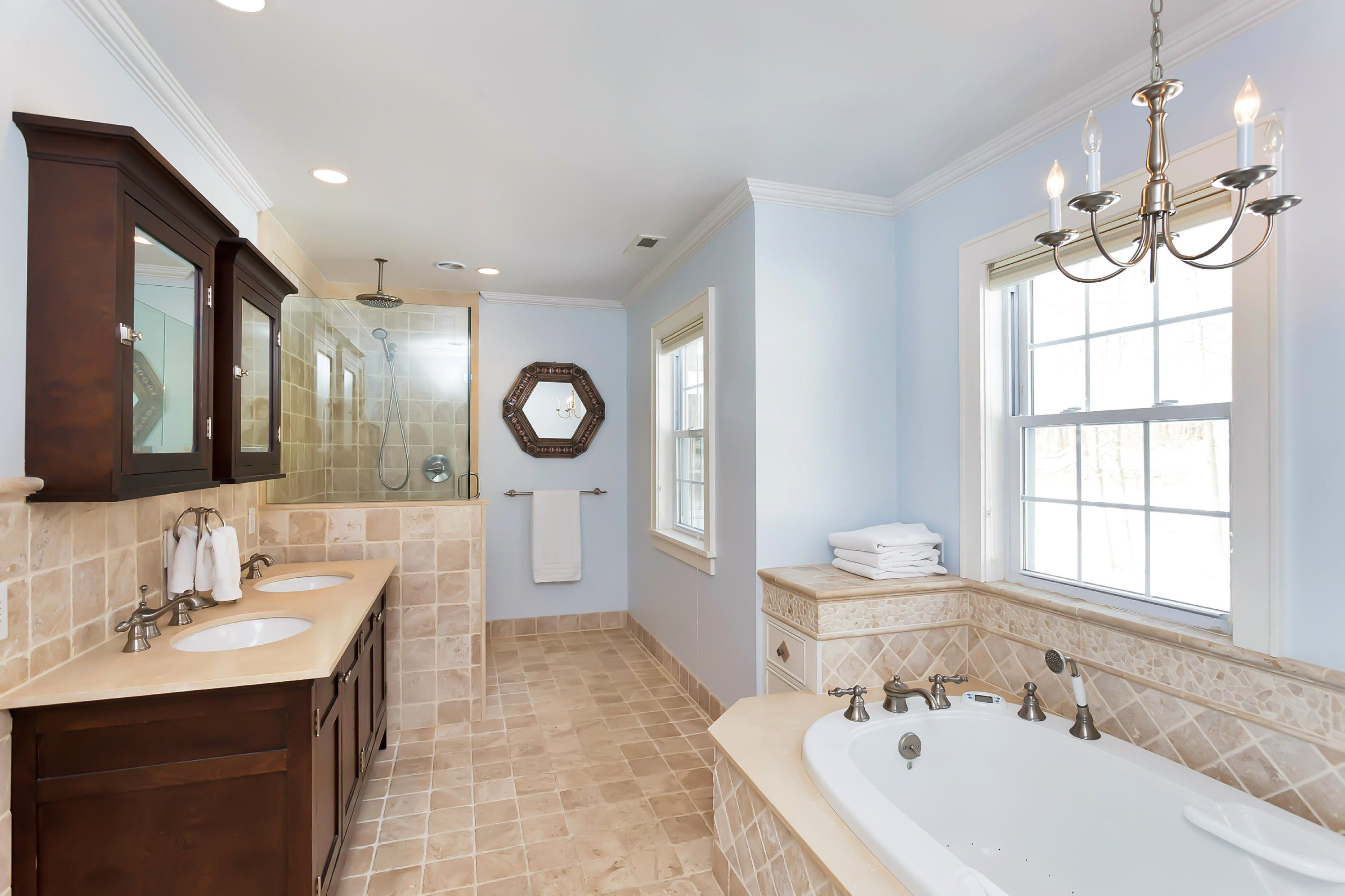 279 Silvermine Road New Canaan, CT 06840 - Photo 15 of 24 a bathroom with a bathtub a double vanity sink a mirror a window and vanity