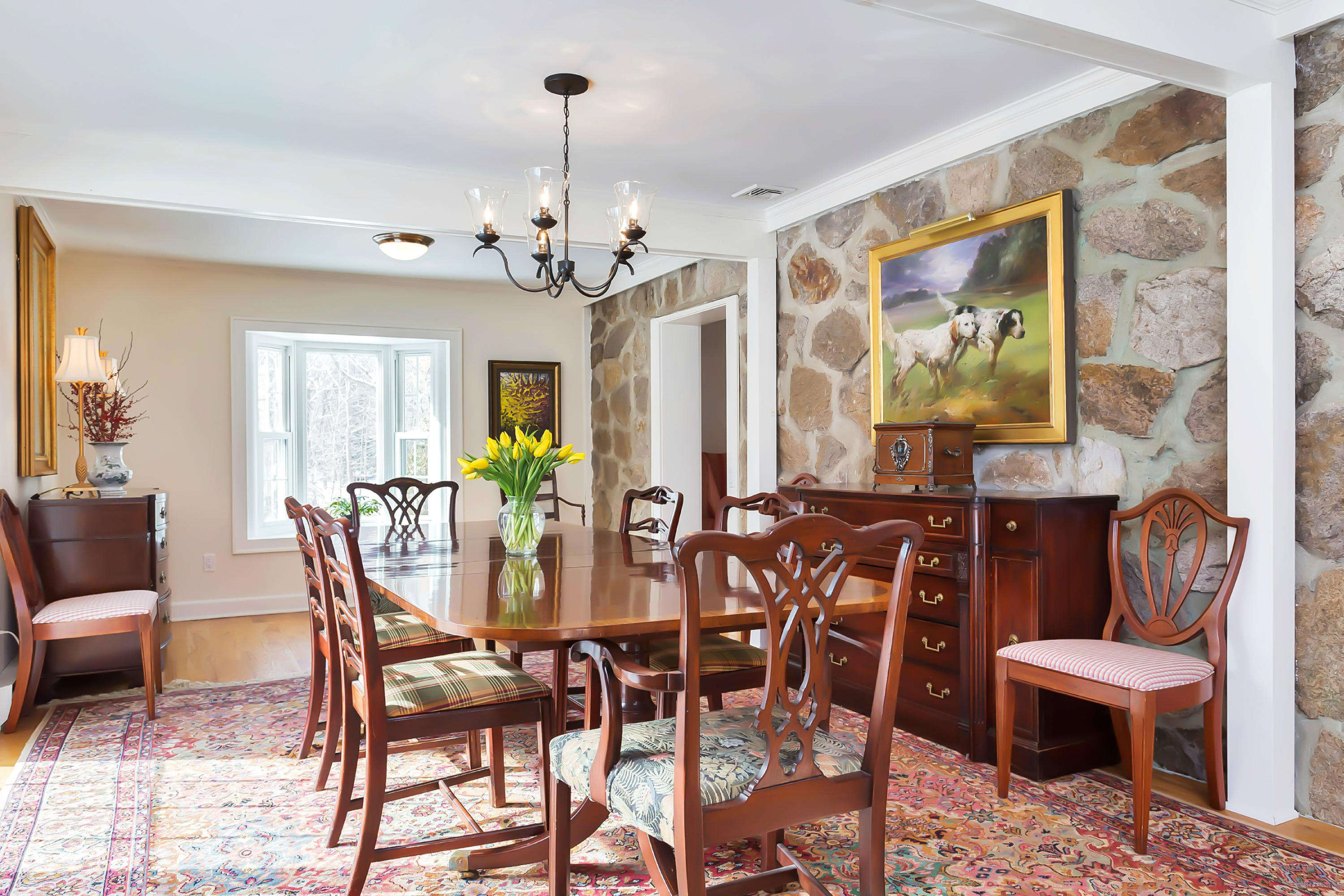 279 Silvermine Road New Canaan, CT 06840 - Photo 5 of 24 a view of a dining room with furniture and chandelier