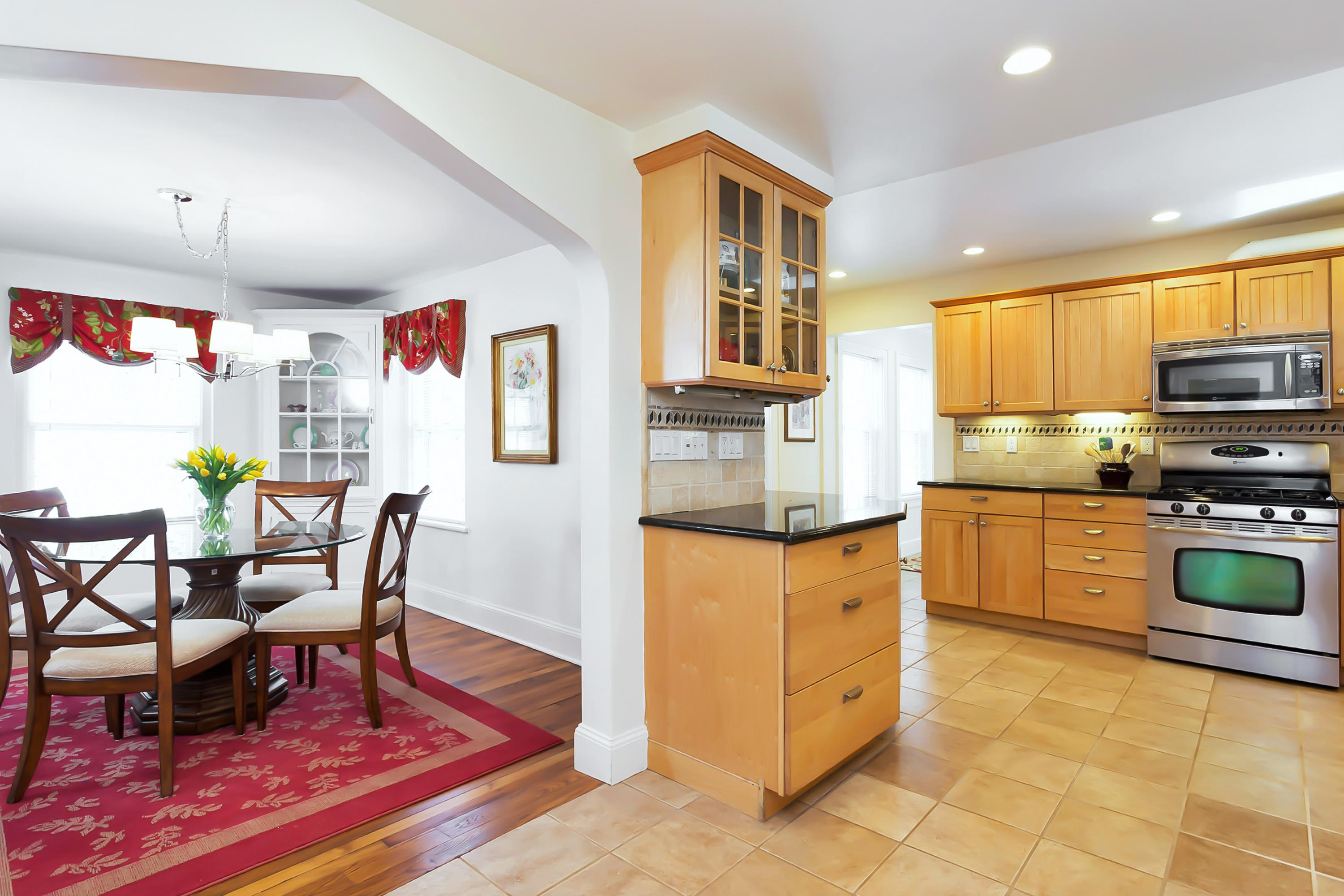 279 Silvermine Road New Canaan, CT 06840 - Photo 8 of 24 a kitchen with stainless steel appliances granite countertop a stove top oven a sink a dining table and chairs