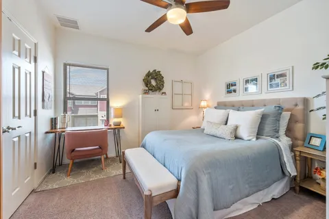 a bedroom with a bed and a chandelier