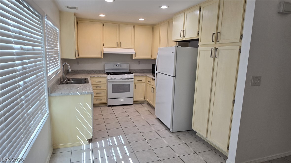 3849 Reflection Way Las Vegas, NV 89147 - Photo 8 of 25 This functional kitchen features ample cabinet storage and essential appliances for everyday meal preparation.