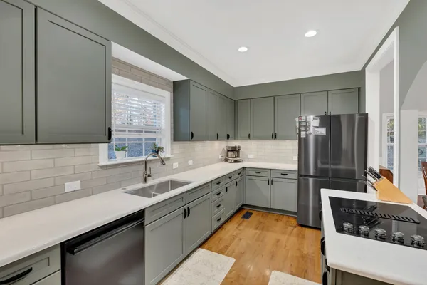 a kitchen with a sink stove and cabinets
