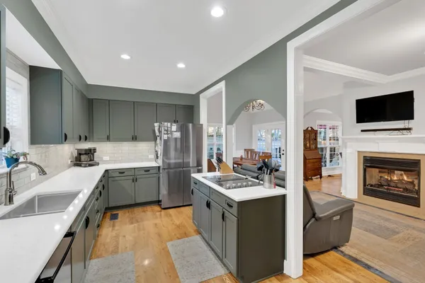 a kitchen with a sink stove top oven and cabinets