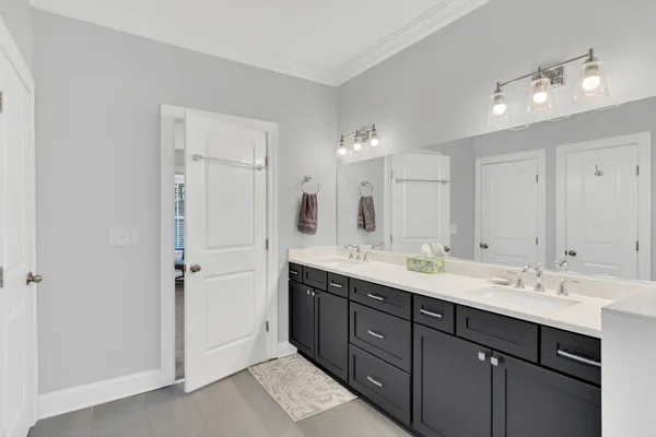 a large bathroom with a glass shower door and a sink