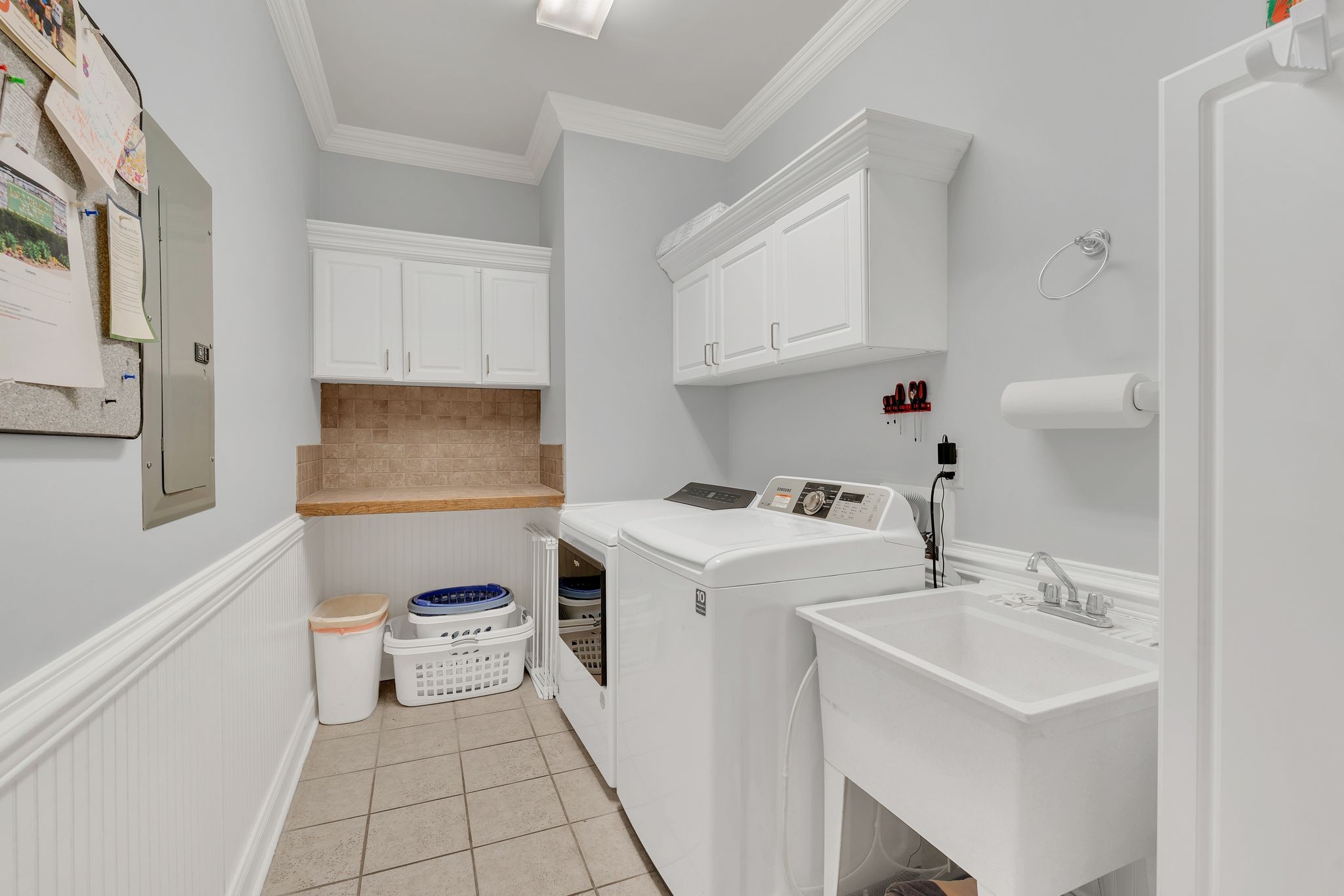 7315 McCormick Drive Fairview, TN 37062 - Photo 29 of 56 a utility room with cabinets washer and dryer