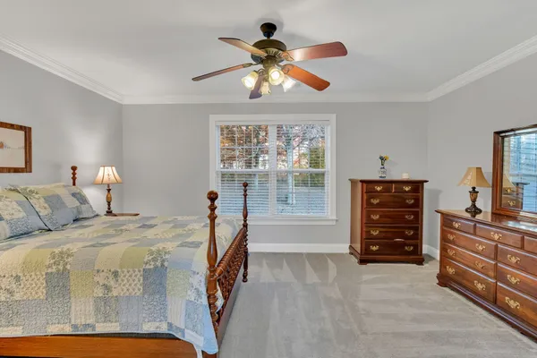 a bedroom with a bed and window
