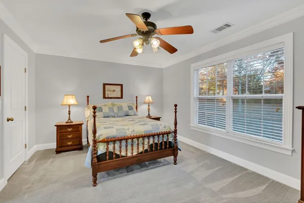 a bedroom with a large bed and a dresser
