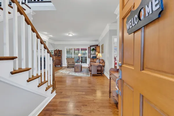 a view of entryway and hall with wooden floor