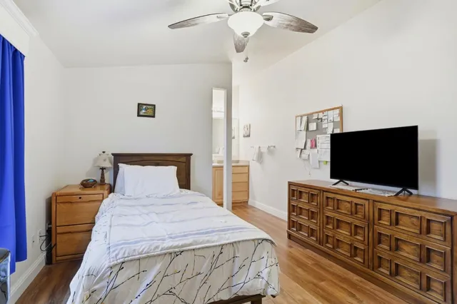 a bedroom with a bed and a flat screen tv