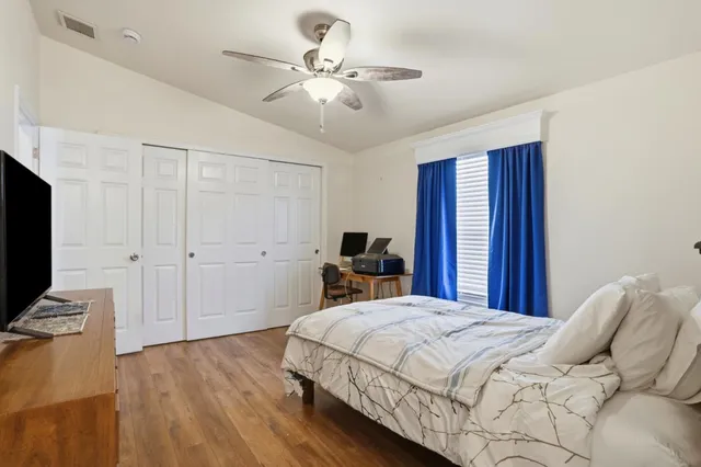 a bedroom with a bed and a flat screen tv