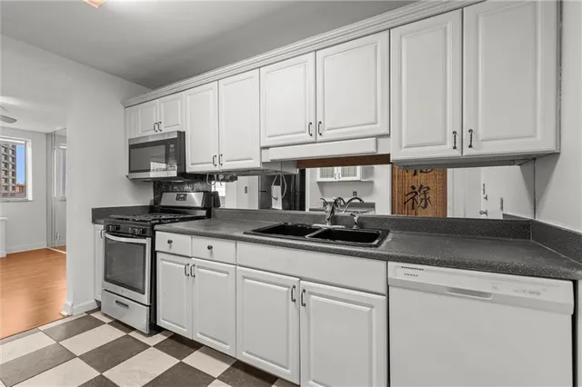a kitchen with stainless steel appliances granite countertop a sink stove and cabinets