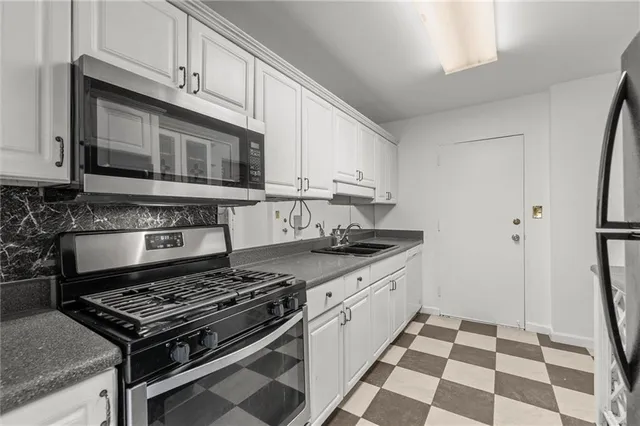 a kitchen with stainless steel appliances granite countertop a stove and a sink