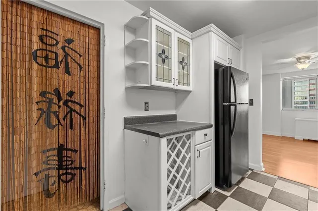 a kitchen with stainless steel appliances granite countertop a refrigerator and a stove