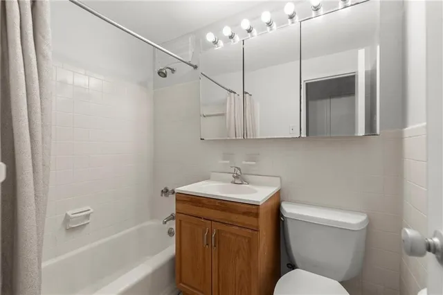 a bathroom with a sink a toilet and bathtub