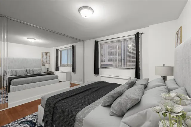 a bedroom with a large bed and a large window