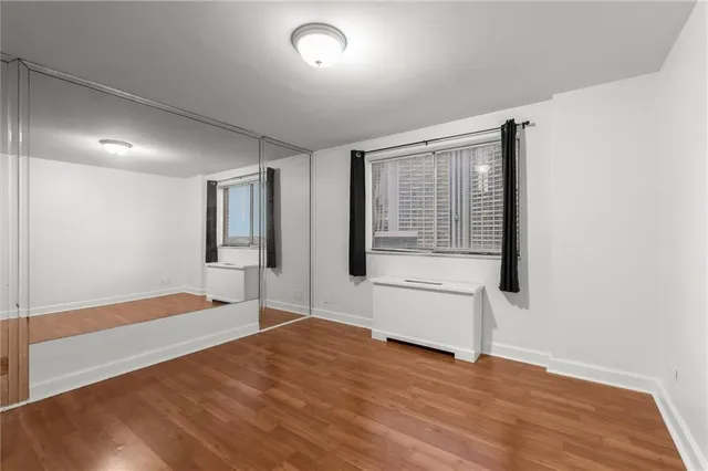 a big room with wooden floor and windows