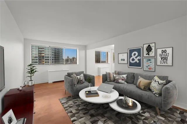 a living room with furniture and a wooden floor