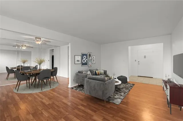 a living room with furniture and a wooden floor