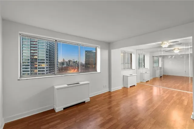 a room with wooden floor and windows