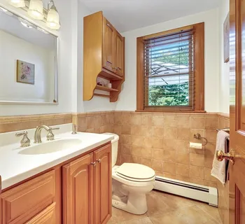 a bathroom with a sink a toilet and a mirror