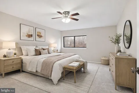 an empty room with a ceiling fan and a window