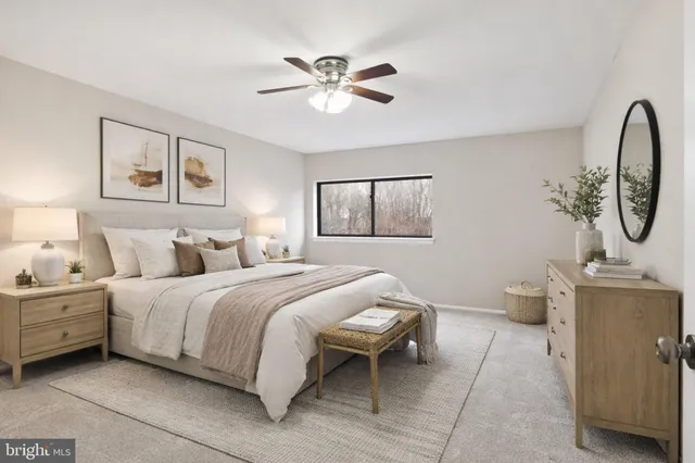 an empty room with a ceiling fan and a window