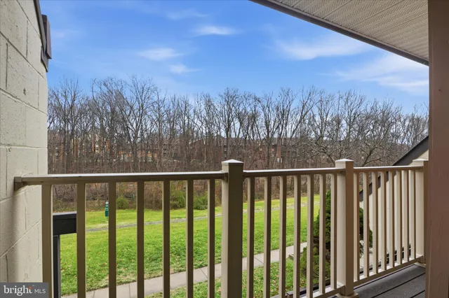 a view of a balcony with a forest